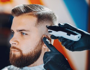 customer getting a hair cut from Gadsden Alabama barber